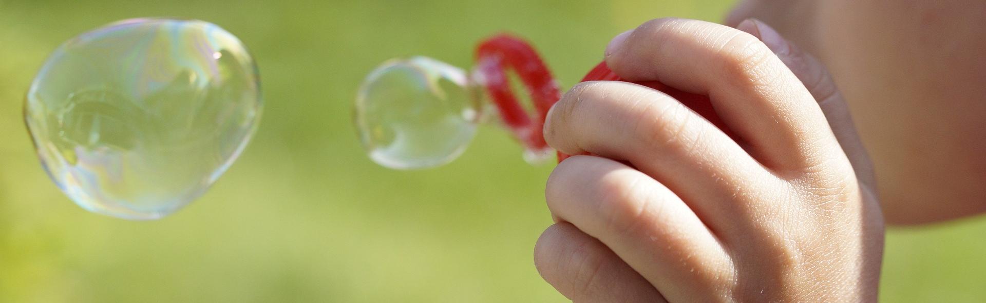 Toddler blowing bubbles.